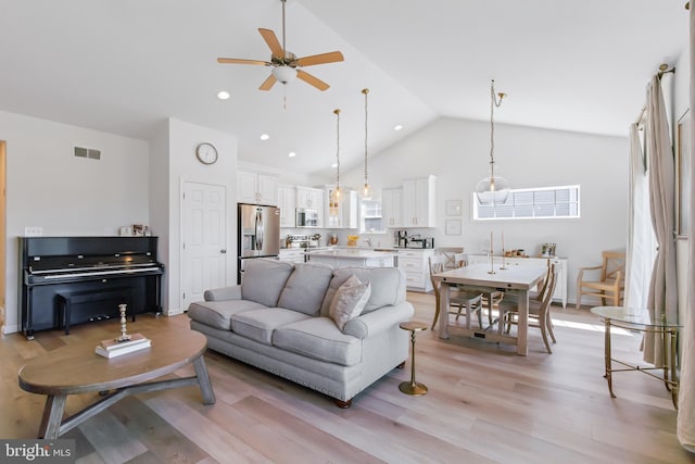 living area with light wood finished floors, visible vents, ceiling fan, recessed lighting, and high vaulted ceiling