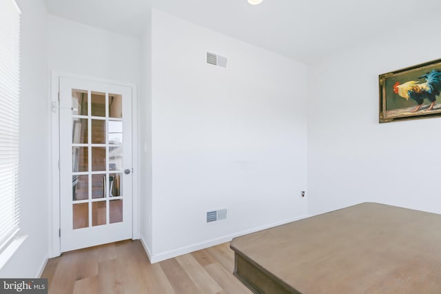 unfurnished bedroom with visible vents, baseboards, and light wood finished floors