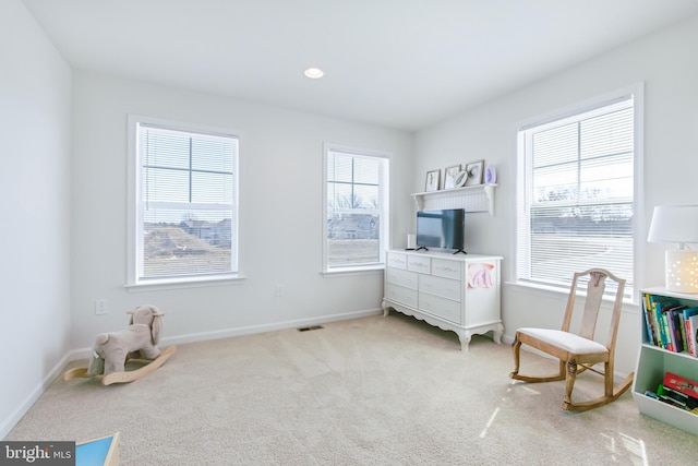 interior space featuring recessed lighting, baseboards, visible vents, and light carpet