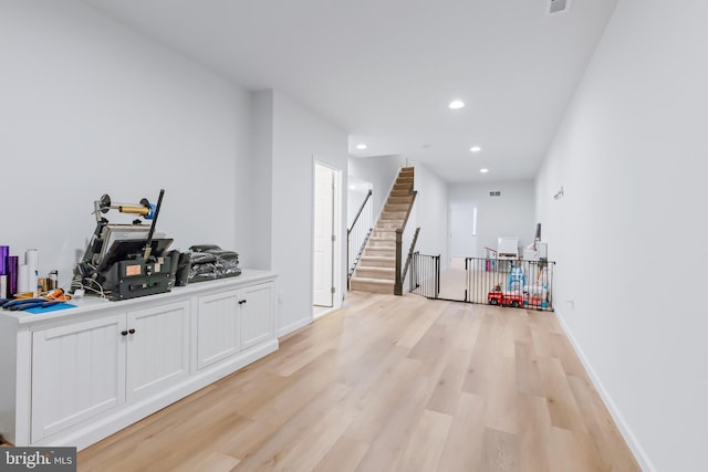 interior space with light wood finished floors, stairway, recessed lighting, and baseboards