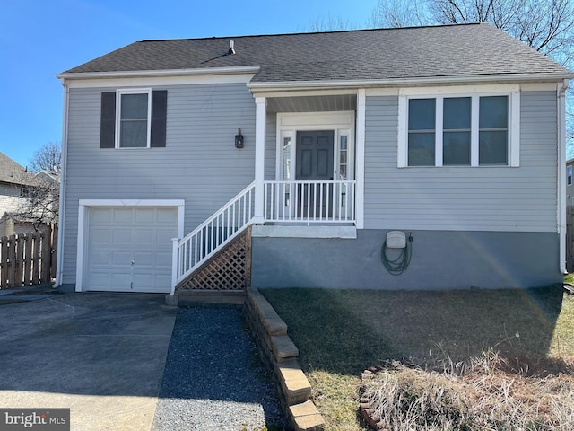 view of front of home featuring an attached garage, fence, driveway, and a shingled roof