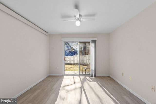 unfurnished room featuring ceiling fan, baseboards, and wood finished floors