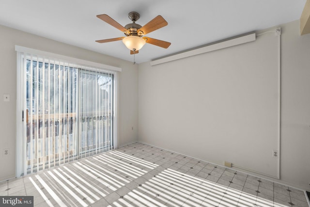 empty room with light floors and a ceiling fan