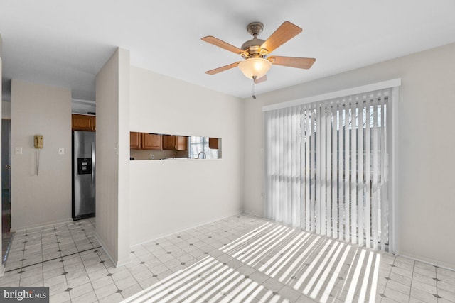 interior space featuring light floors and ceiling fan