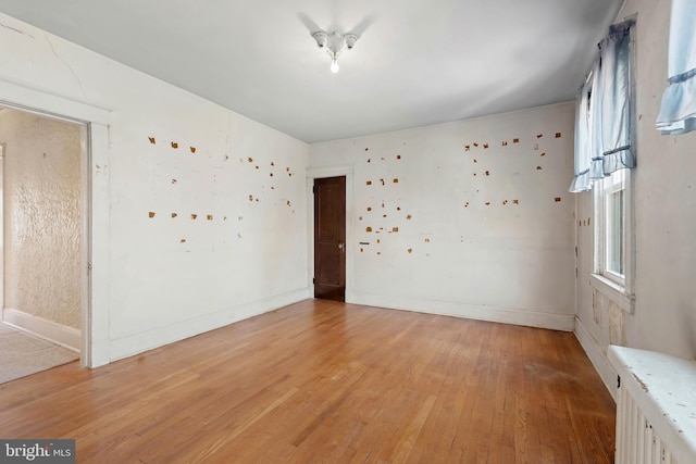 empty room with light wood-style floors and baseboards