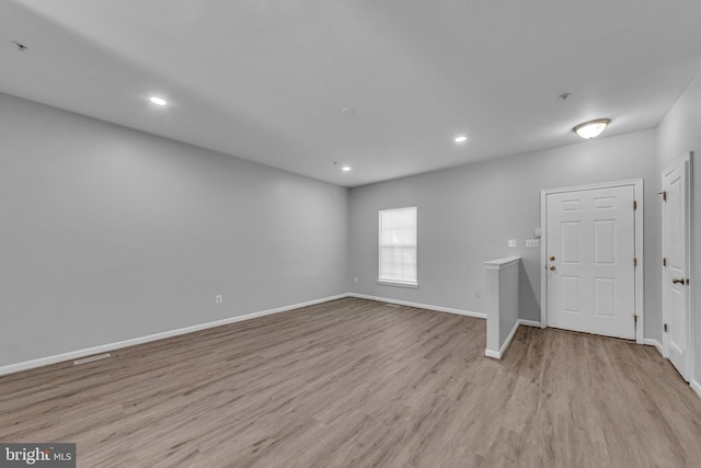 unfurnished living room with recessed lighting, baseboards, and wood finished floors