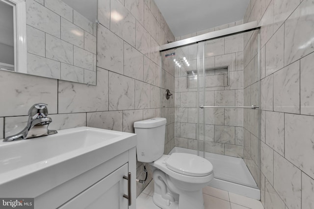 full bath featuring toilet, a shower stall, tile walls, and vanity