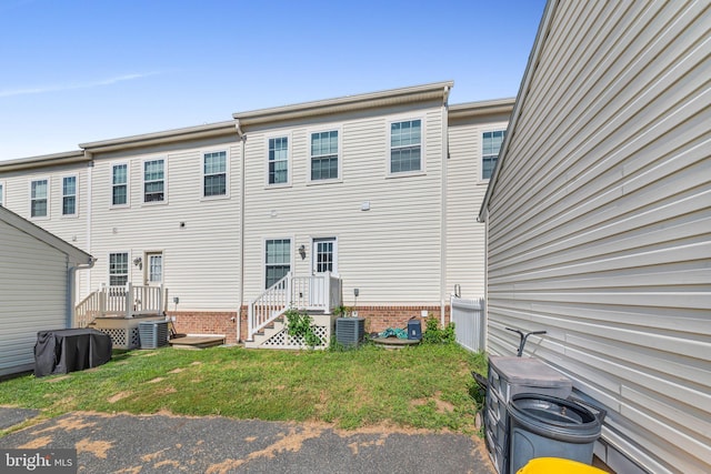 back of property featuring a yard and central AC unit