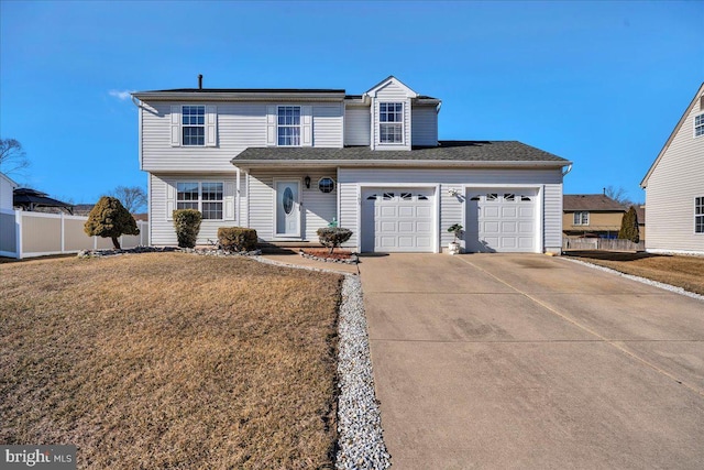 traditional-style home featuring a garage, concrete driveway, a front yard, and fence