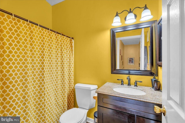 full bath featuring toilet, a shower with shower curtain, and vanity