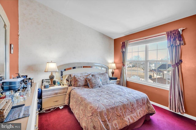 bedroom featuring carpet and baseboards