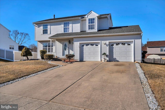 traditional-style house featuring driveway, fence, and a front yard