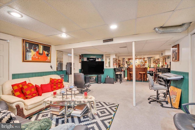 living area with a paneled ceiling, recessed lighting, carpet flooring, visible vents, and a bar