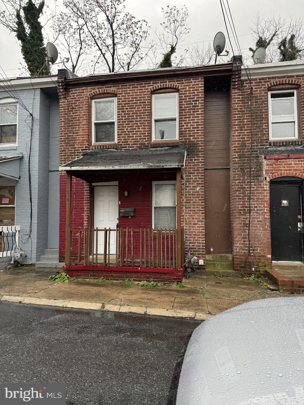 multi unit property featuring entry steps and brick siding