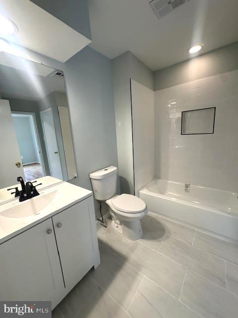 bathroom with toilet, shower / washtub combination, vanity, and visible vents