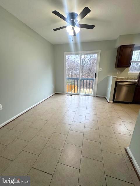 unfurnished living room featuring light tile patterned floors, ceiling fan, and baseboards