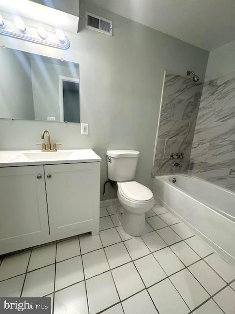 bathroom with shower / bathtub combination, visible vents, toilet, vanity, and tile patterned flooring