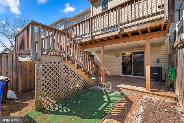 exterior space with stairway, cooling unit, fence, and a wooden deck