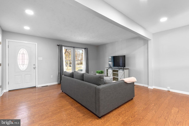 living room with recessed lighting, wood finished floors, and baseboards