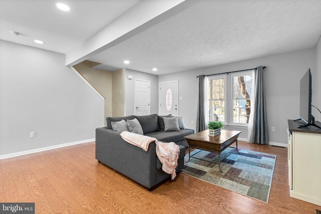 living room featuring recessed lighting, baseboards, and wood finished floors