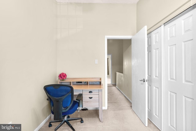 carpeted office space with baseboards