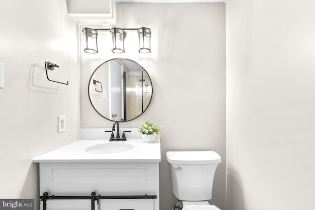 bathroom with toilet and vanity