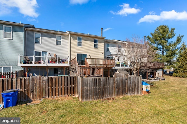 rear view of property featuring a yard and fence