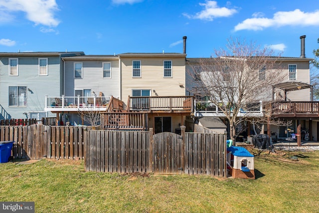 back of house featuring a lawn and fence