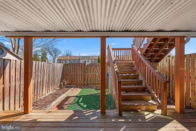 deck with a fenced backyard and stairs