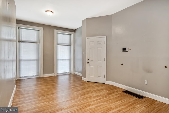 entrance foyer featuring baseboards, visible vents, and light wood finished floors