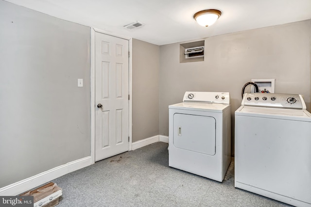 clothes washing area featuring laundry area, baseboards, visible vents, washing machine and clothes dryer, and light floors