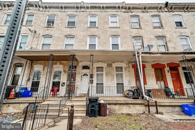 townhome / multi-family property with a porch