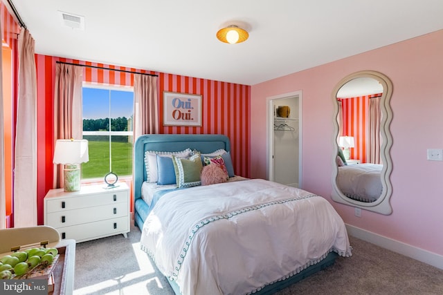 carpeted bedroom with visible vents and baseboards