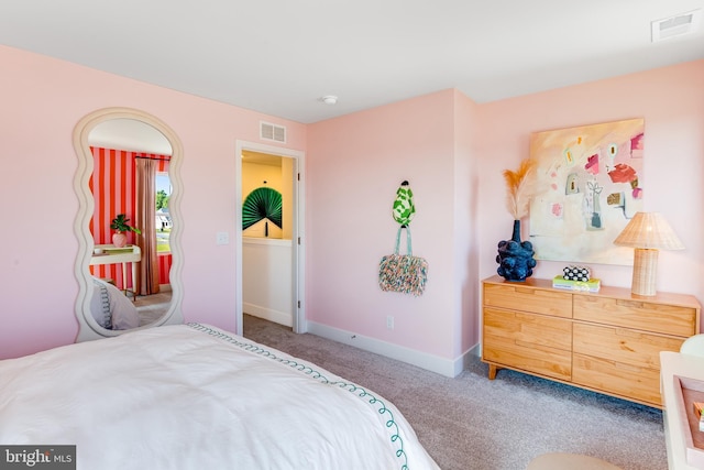 carpeted bedroom featuring baseboards and visible vents