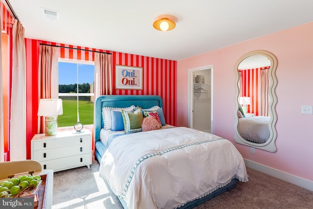 carpeted bedroom featuring visible vents and baseboards