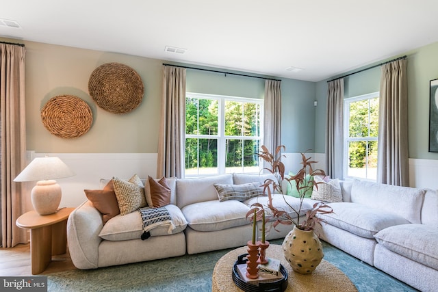 living room featuring visible vents and wood finished floors