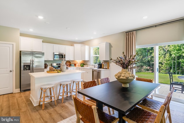 dining space featuring light wood-type flooring and recessed lighting