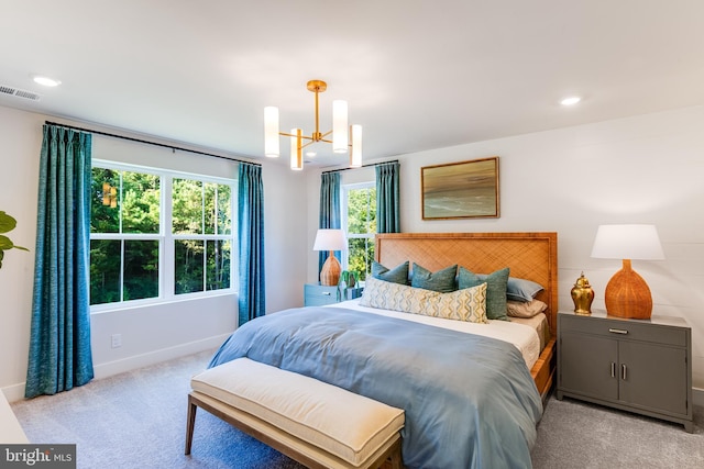 carpeted bedroom featuring baseboards, visible vents, a chandelier, and recessed lighting