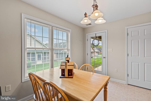 dining room with baseboards, visible vents, and a chandelier