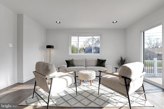 living room with hardwood / wood-style floors, recessed lighting, and baseboards