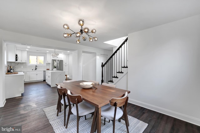 dining area with dark wood-style flooring, a notable chandelier, stairway, and baseboards