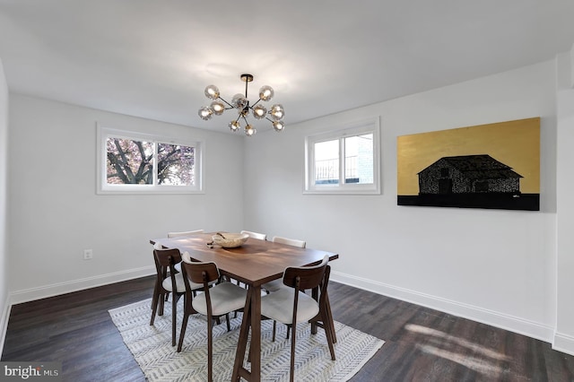 dining space featuring a chandelier, dark wood finished floors, and baseboards