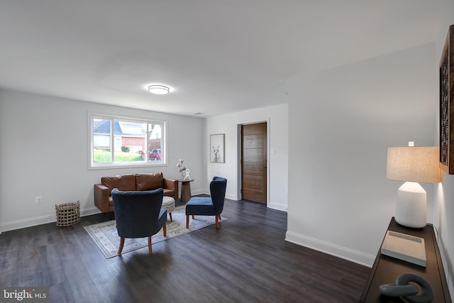 living area with dark wood finished floors and baseboards