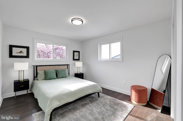 bedroom with hardwood / wood-style flooring and baseboards