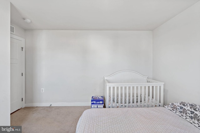 carpeted bedroom with baseboards and visible vents