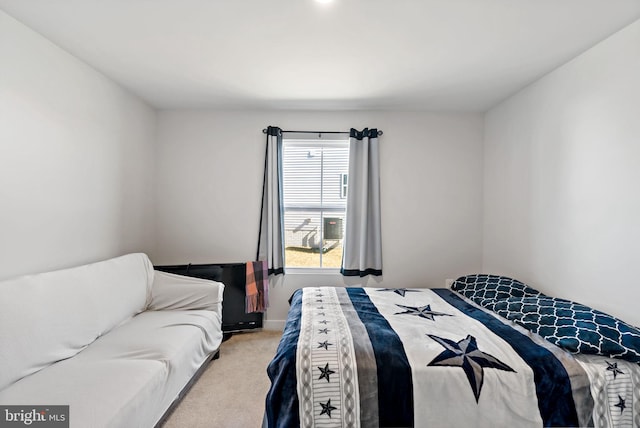 carpeted bedroom featuring baseboards