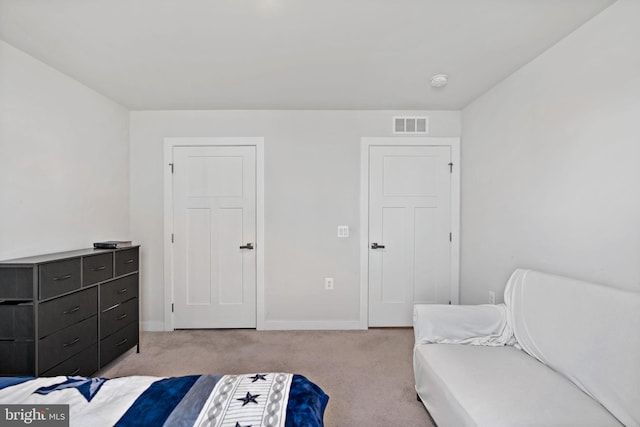 carpeted bedroom with baseboards and visible vents