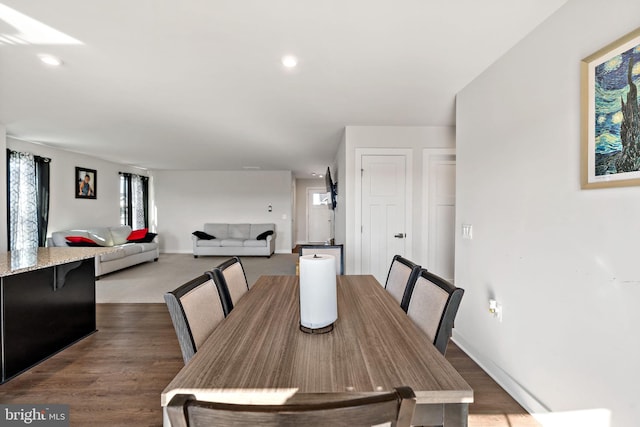 dining room featuring dark wood-type flooring, recessed lighting, and baseboards