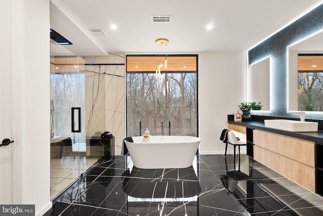 full bathroom with a stall shower, visible vents, marble finish floor, vanity, and a freestanding tub