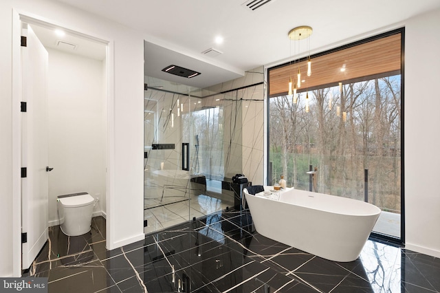 full bath featuring a marble finish shower, visible vents, toilet, marble finish floor, and a freestanding bath